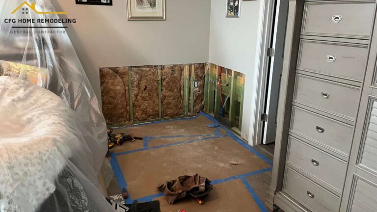 Professional drywall repair expert fixing cracks and smoothing a wall inside a bright modern home.